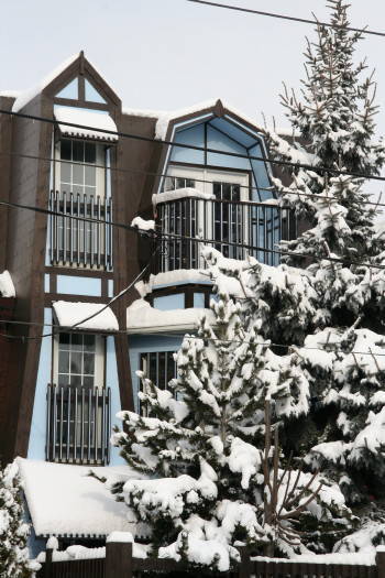 Snow-covered facade offers immediate comfort to visitors coming from the cold.